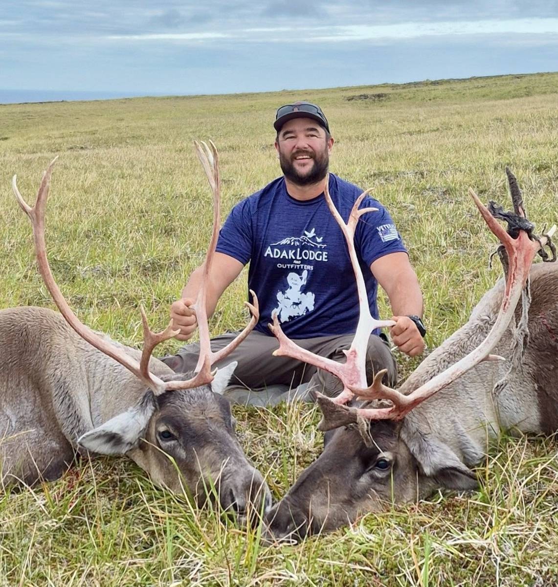 Hunter in Adak Lodge shirt with two massive Caribou bulls