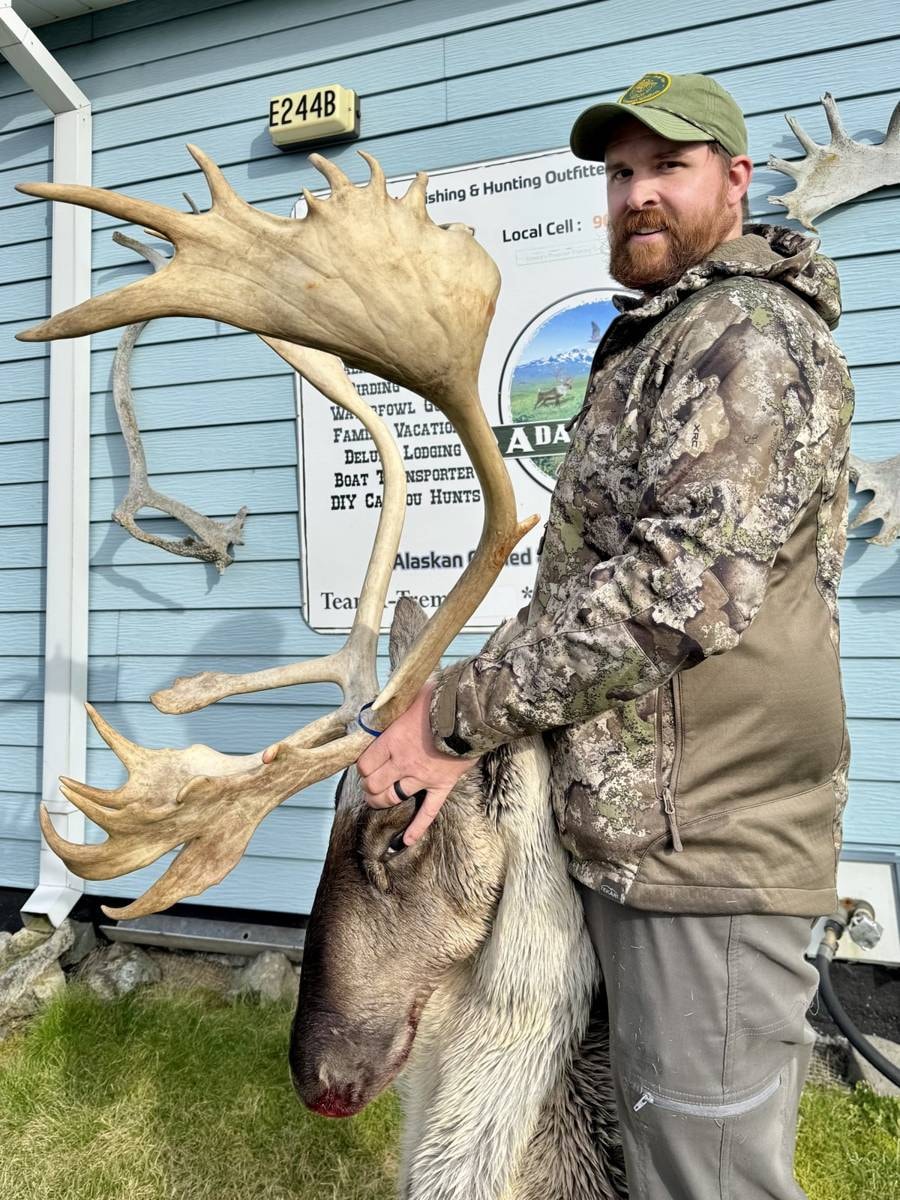 Bearded hunter with a massive Caribou rack