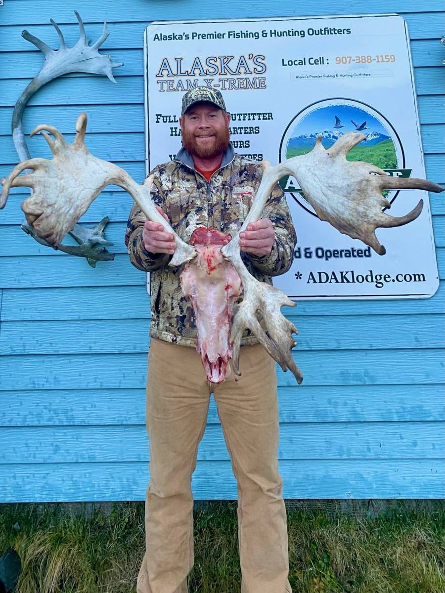 Hunter holding a wide Caribou skull trophy