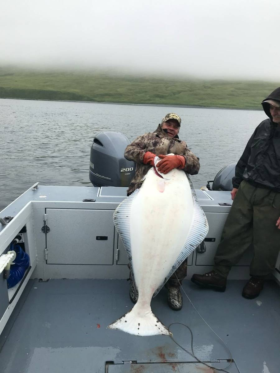 Man holding halibut trophy on boat