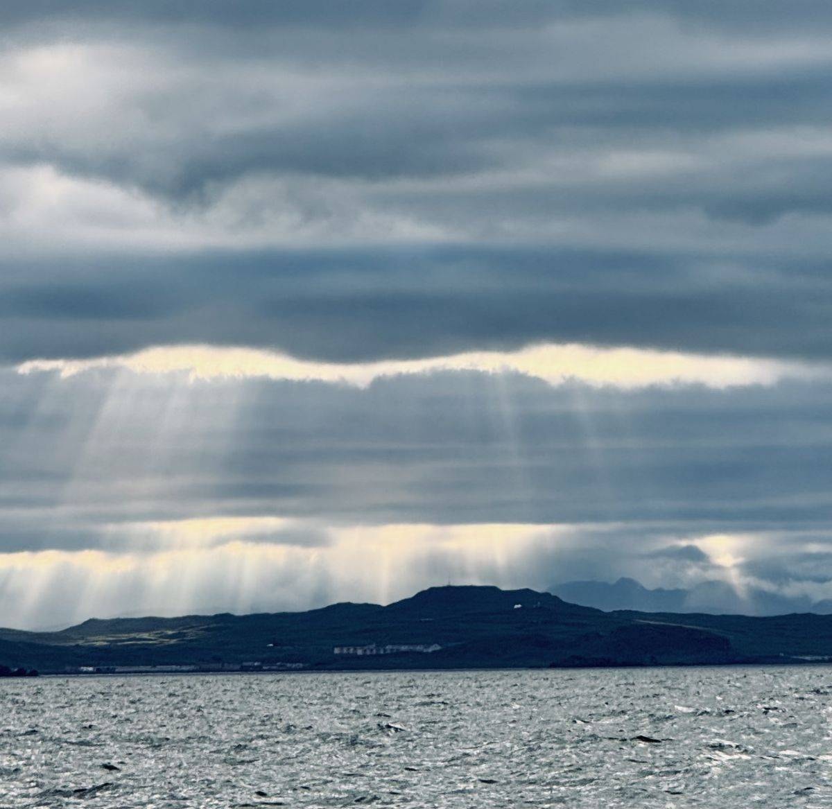 God rays breaking through clouds over the Adak ocean