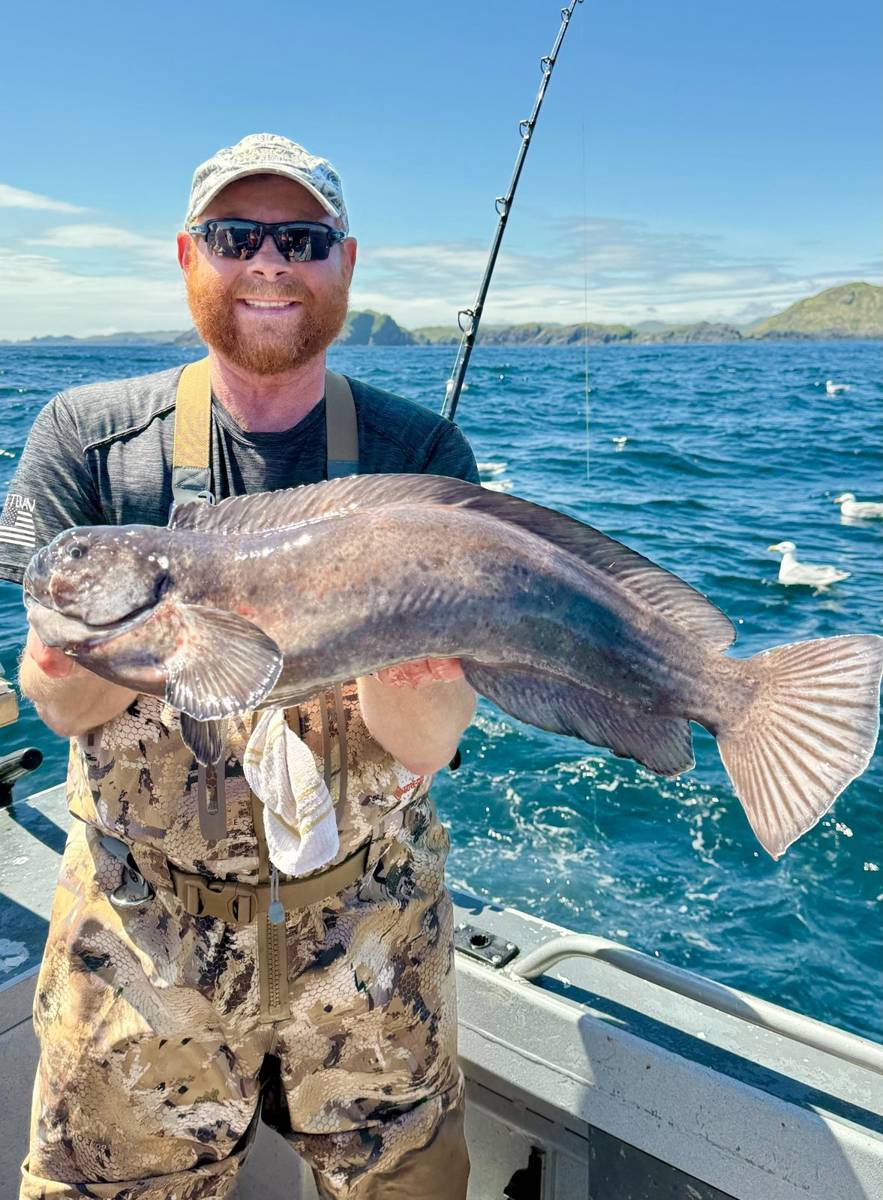 Capt. Chris Tolliver on the boat with a trophy Lingcod