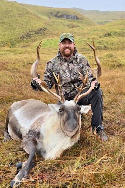 Hunter with Caribou bull