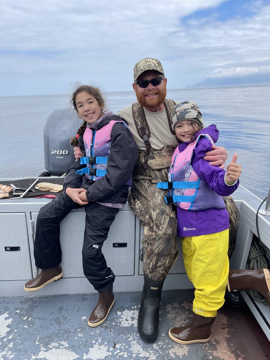 Capt. Chris with two kids on the boat