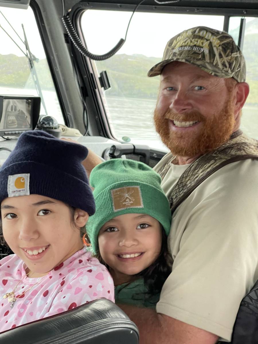 Capt. Chris with two kids in the wheelhouse