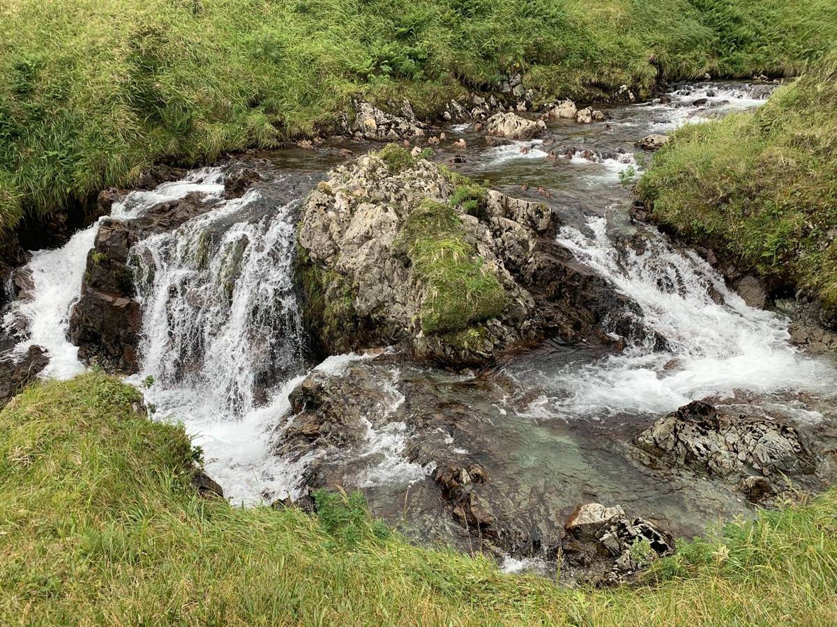 Tiered waterfall in a green Adak creek
