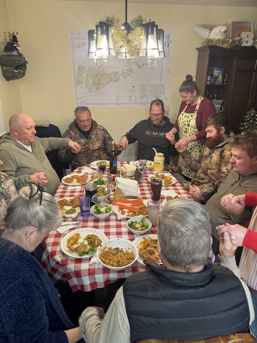 Family-style crab and fried fish dinner around the lodge table